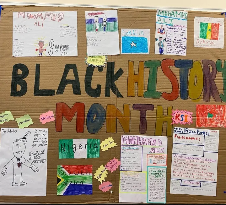 Children's colourful Black History Month wall display with drawings and flags